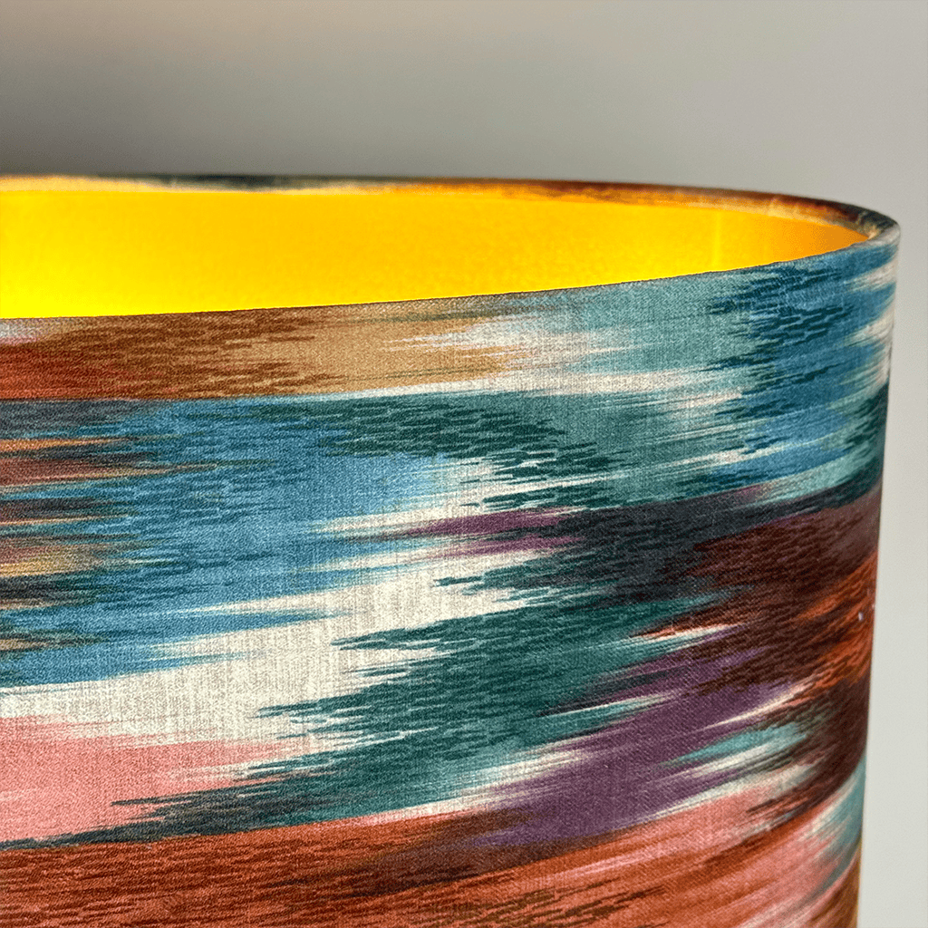 Colorful abstract patterned vase with a yellow rim on a light gray background