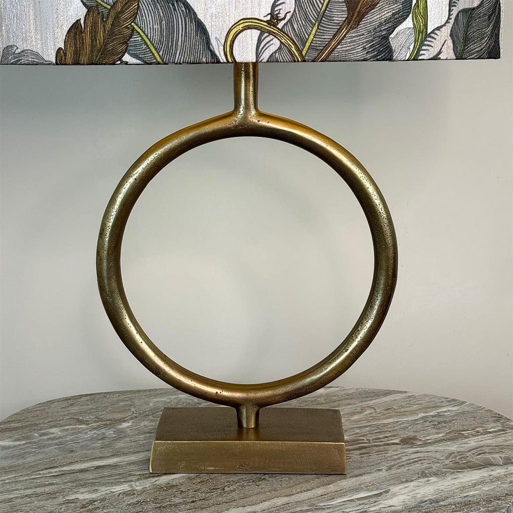 Decorative lamp with circular brass base on a marble surface