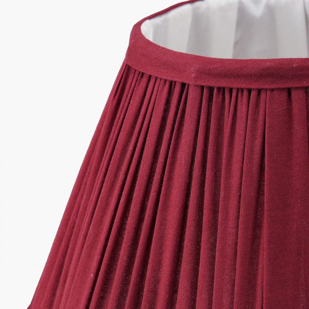 Close-up of a red pleated shade on a white background