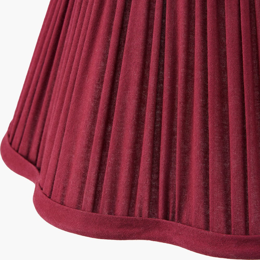 Close-up of a pleated red fabric texture on a white background