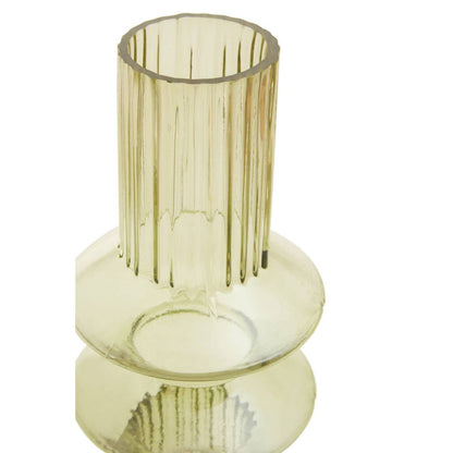 Green glass vase with ribbed design on a white background