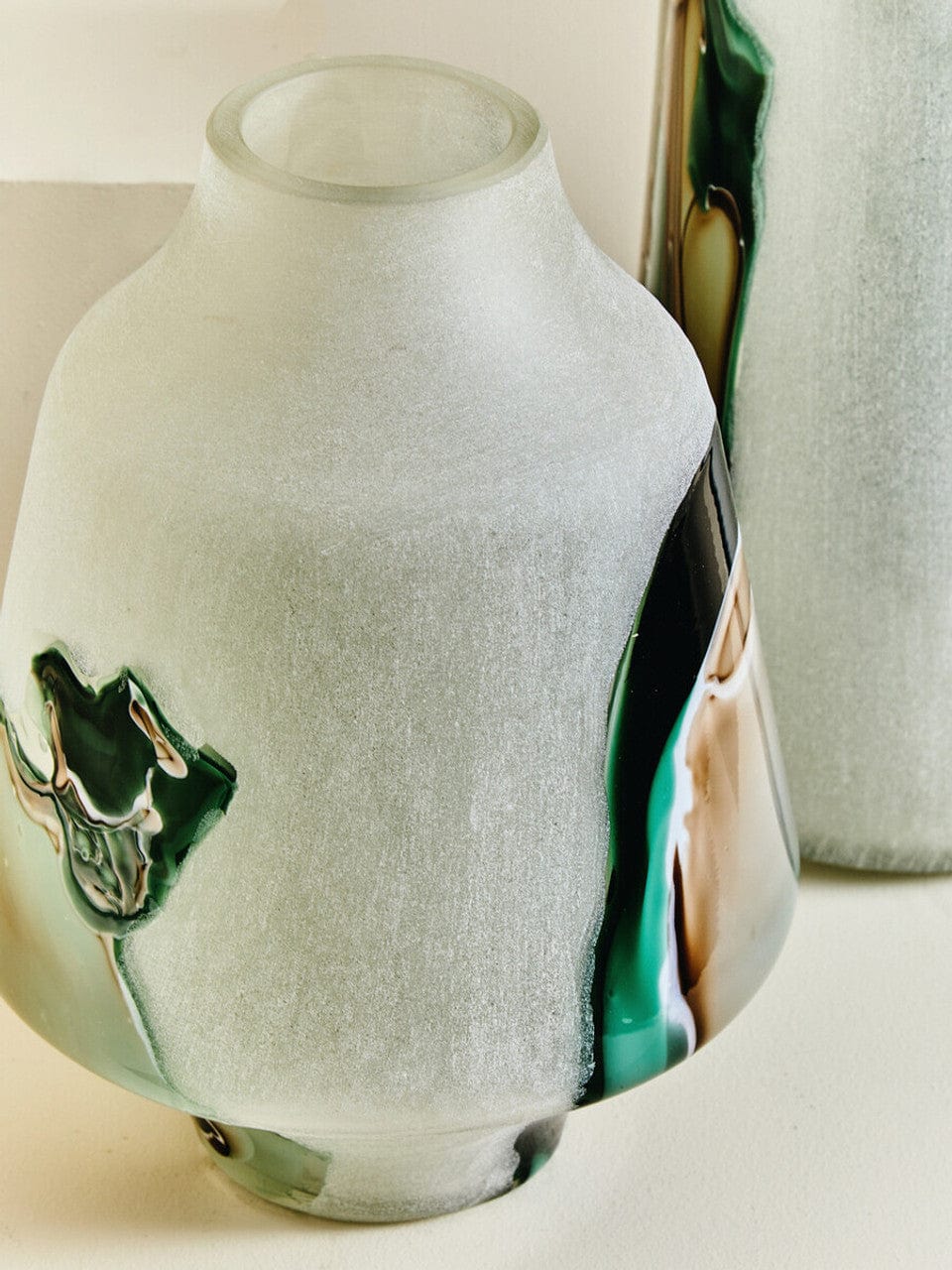 Decorative vase with a bull emblem on a white surface