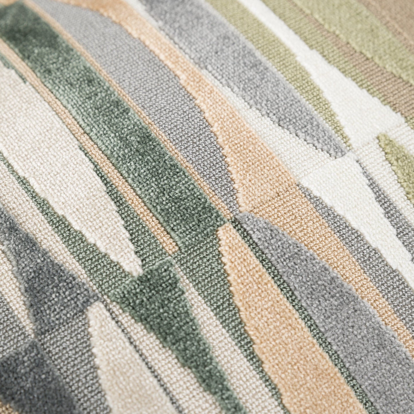 Close-up of a textured fabric with horizontal stripes in green, beige, and white.