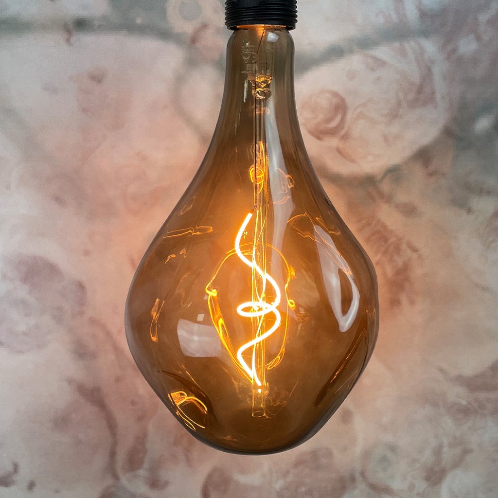 An E27 Organic XXL Natural LED Bulb with a smoked glass enclosure and visible filament inside, lit and hanging