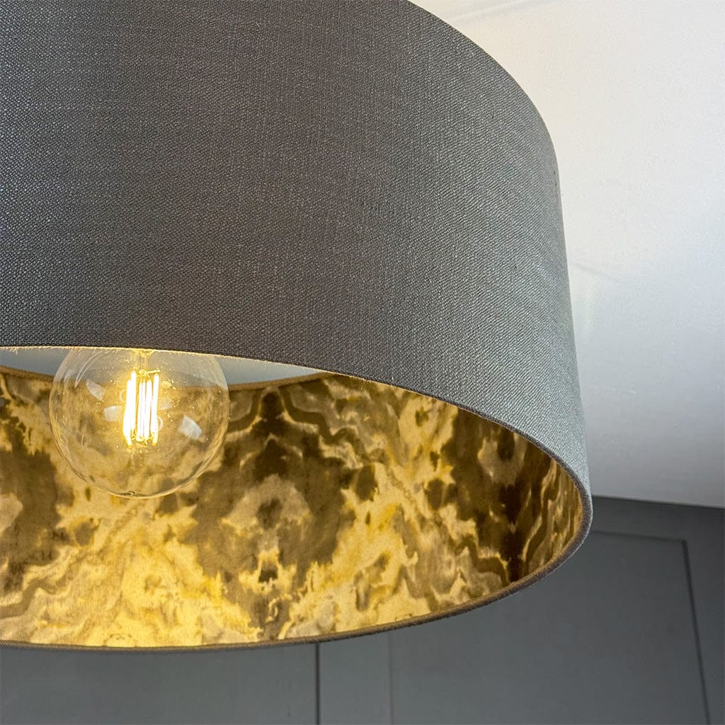 Lamp with a dark gray shade and gold interior