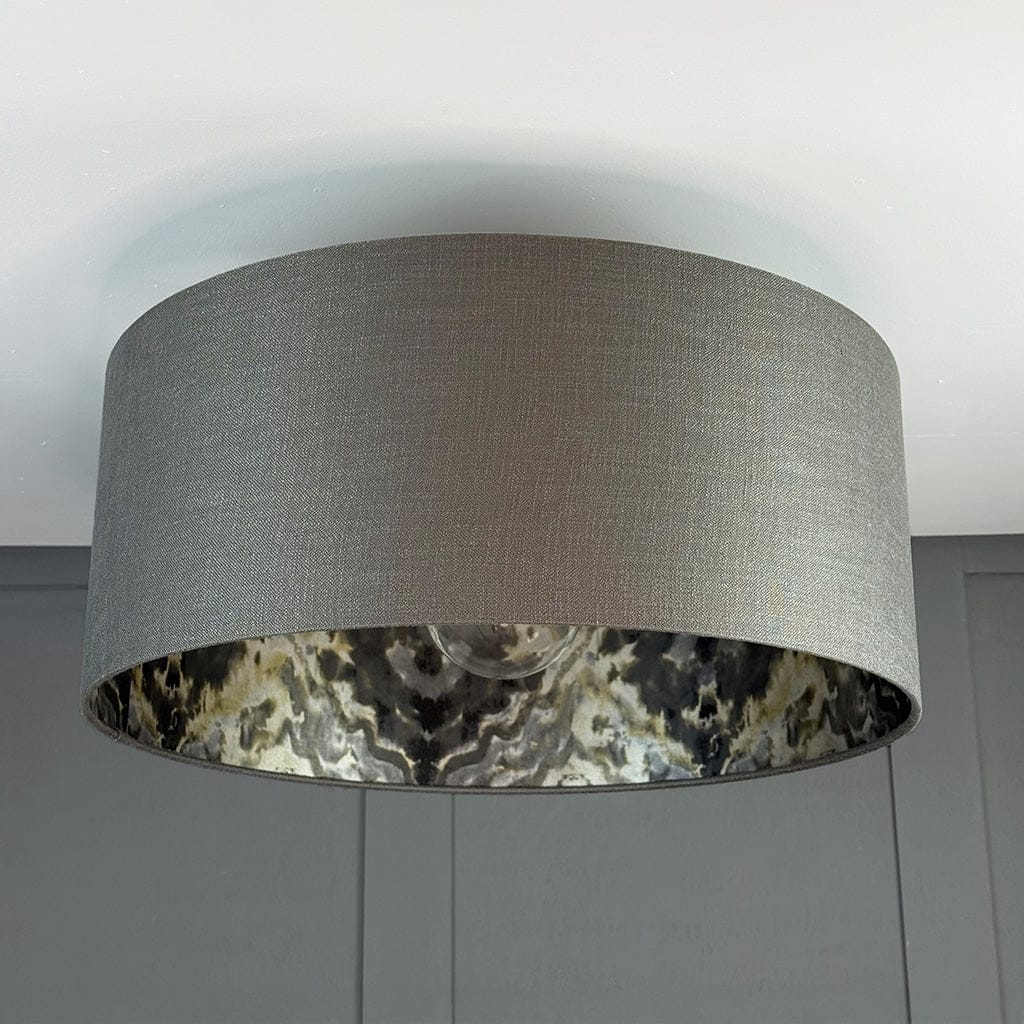 Gray lampshade with a patterned inner lining on a neutral background