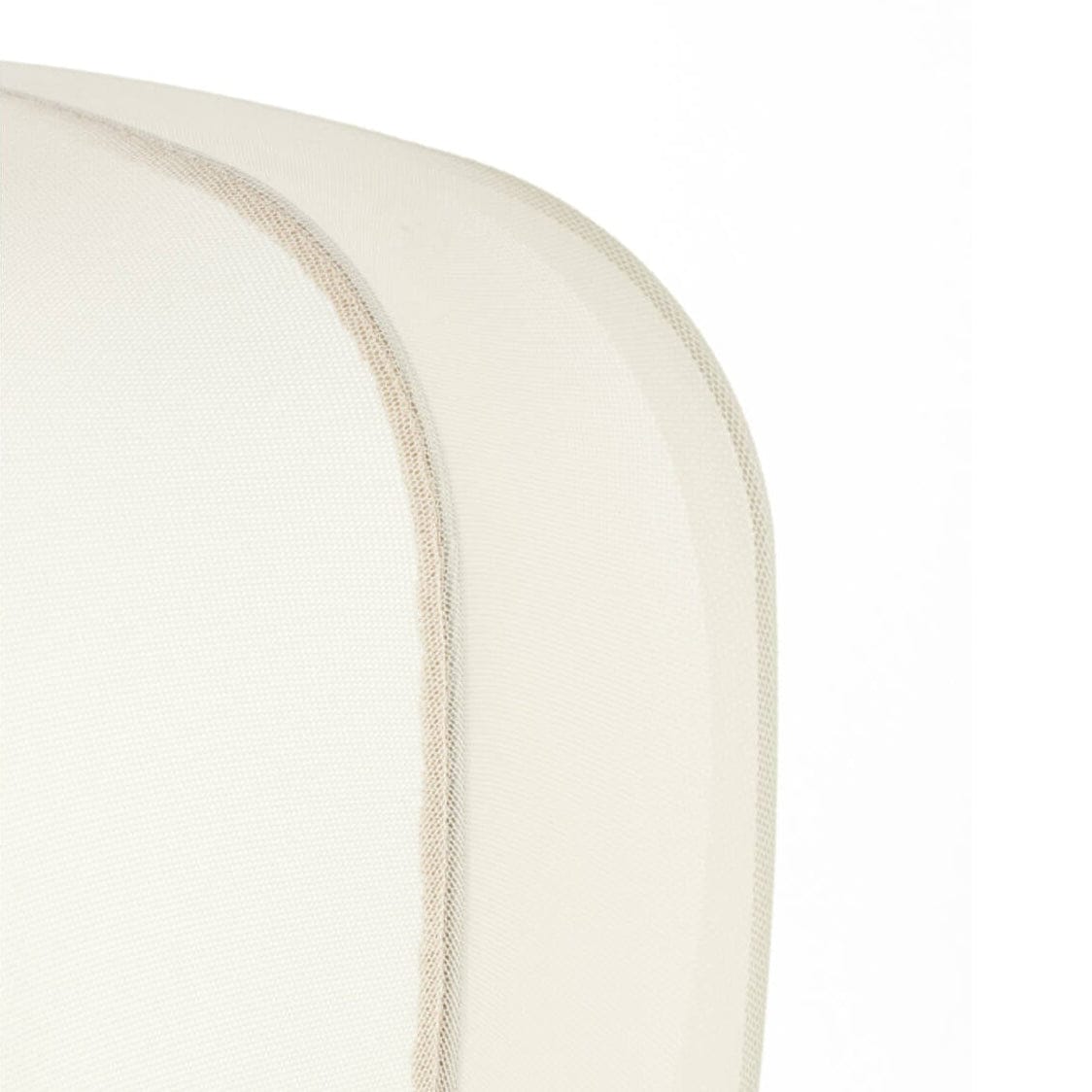 Close-up of a white cushion with a subtle pattern on a white background