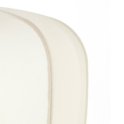 Close-up of a white cushion with a subtle pattern on a white background