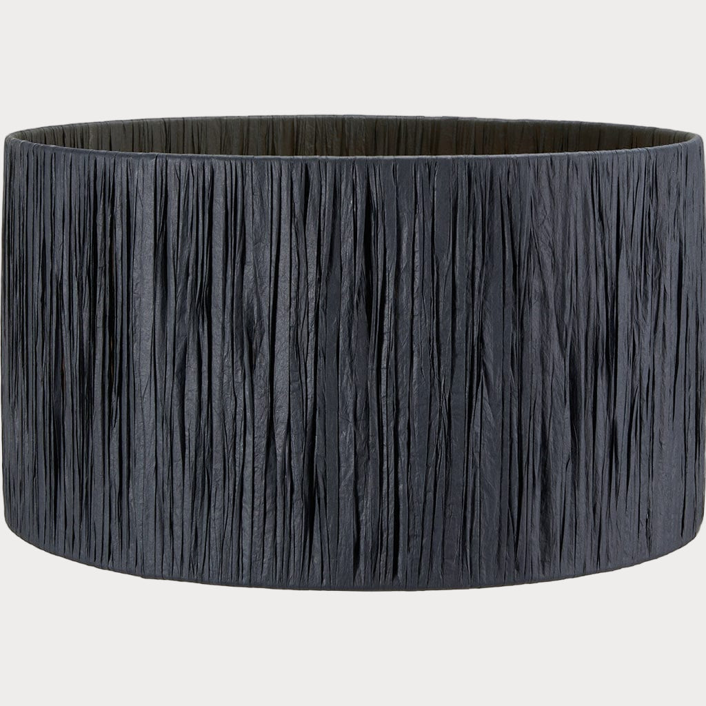 A cylindrical lampshade with black raffia material