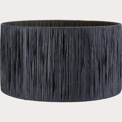 A cylindrical lampshade with black raffia material