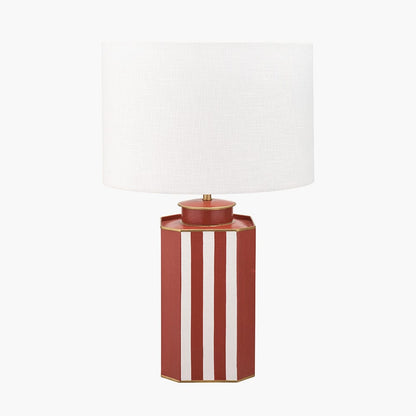 Table lamp with a red and white striped base on a white background