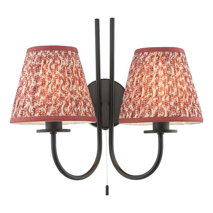 Double wall sconce with red patterned lampshades on a white background