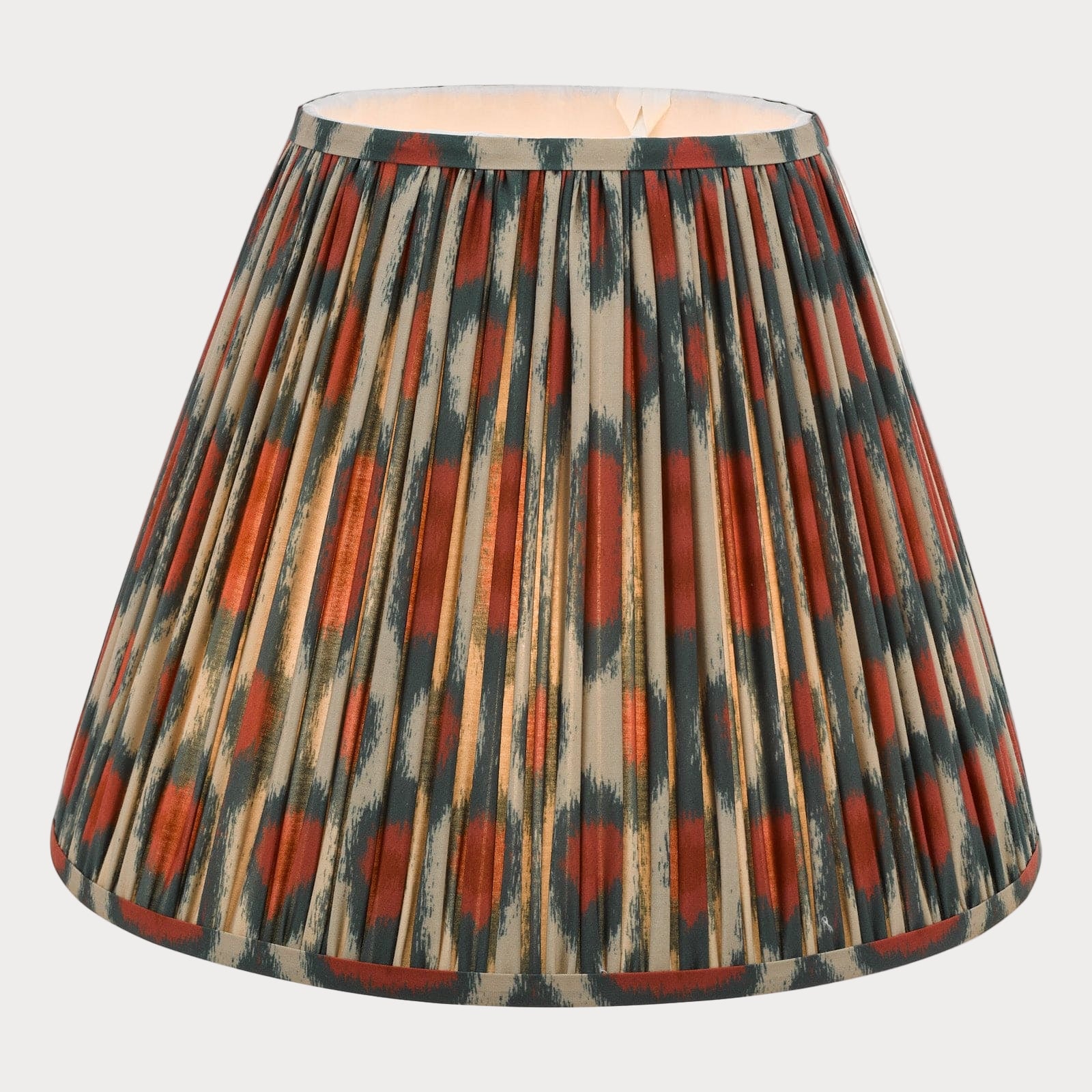 A tapered shade with a bold red and green ikat pattern on a cotton fabric, suitable for chandeliers or wall light fixtures.