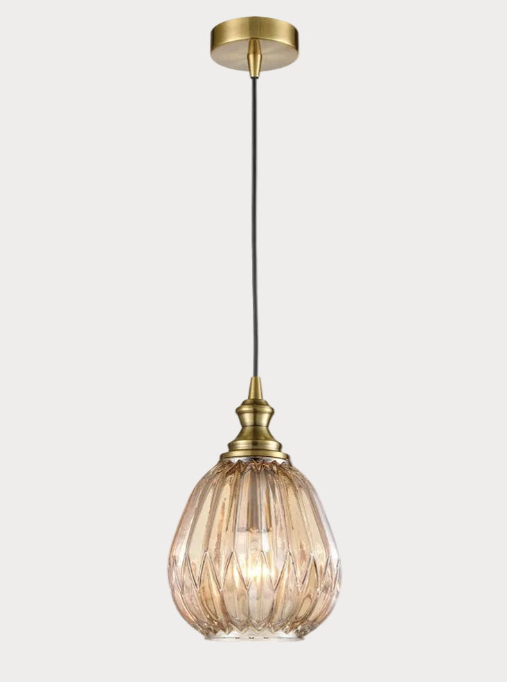 Gold pendant light with glass shade on a white background