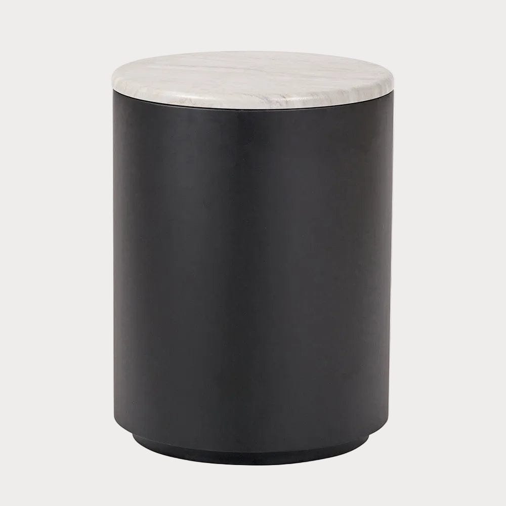 Black cylindrical side table with a marble top on a white background