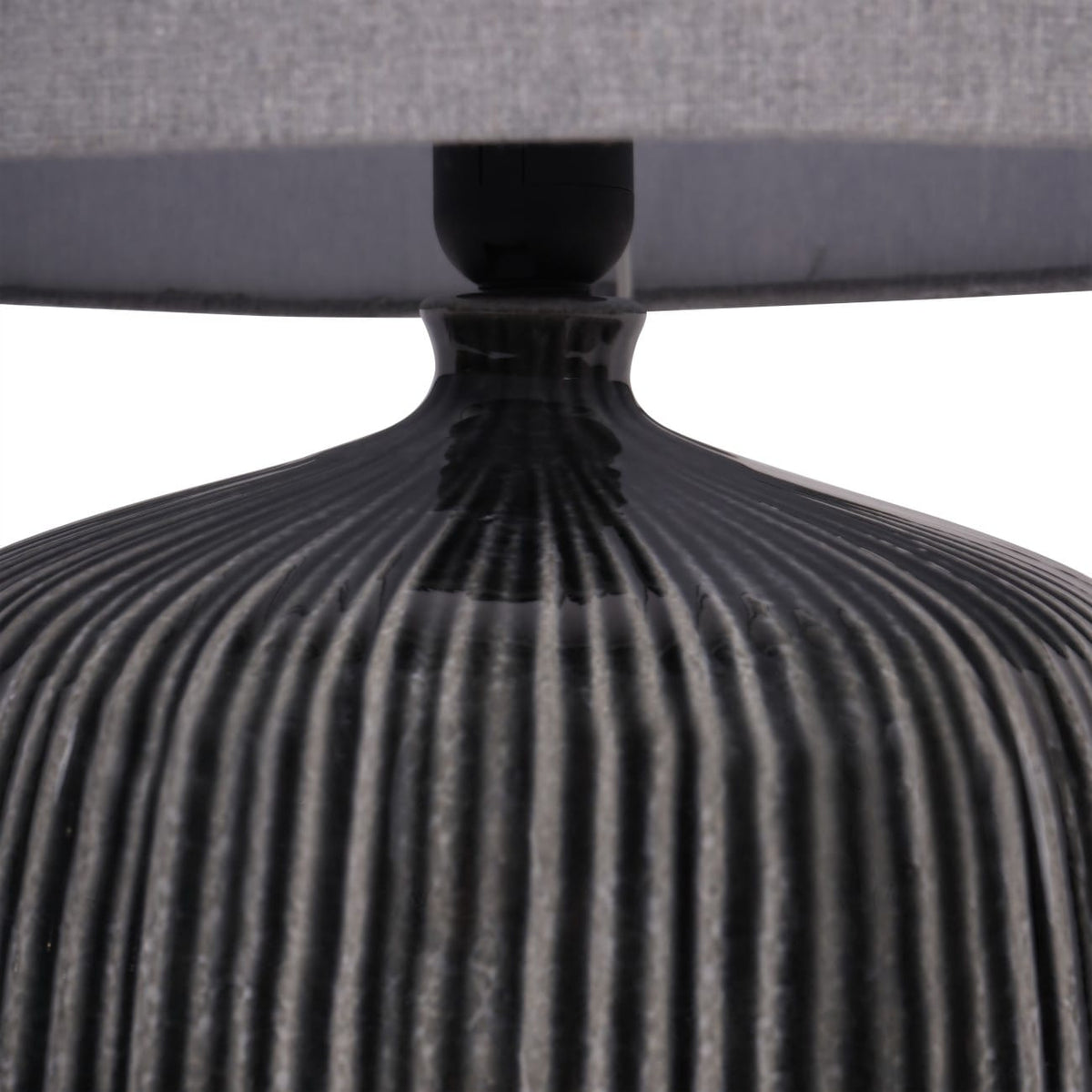 Close-up of a textured black base with a gray cushioned surface on a white background