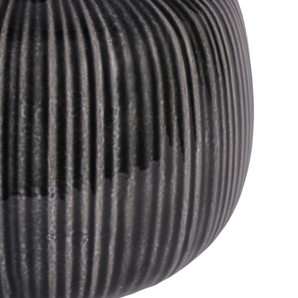 Close-up of a ribbed black object on a white background