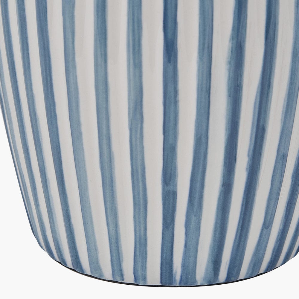 Close-up of a cylindrical container with blue and white striped pattern