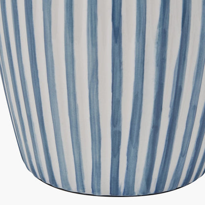 Close-up of a cylindrical container with blue and white striped pattern