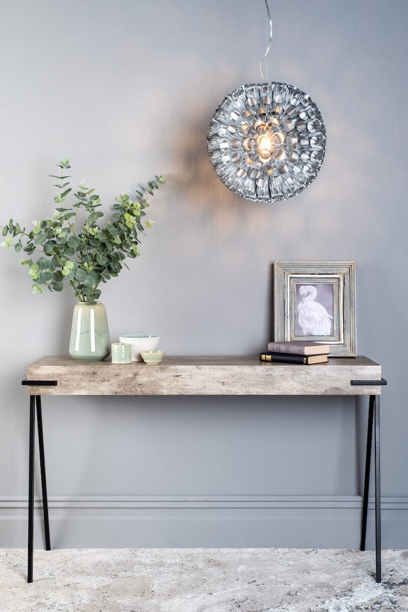 Console table with decorative items against a gray wall