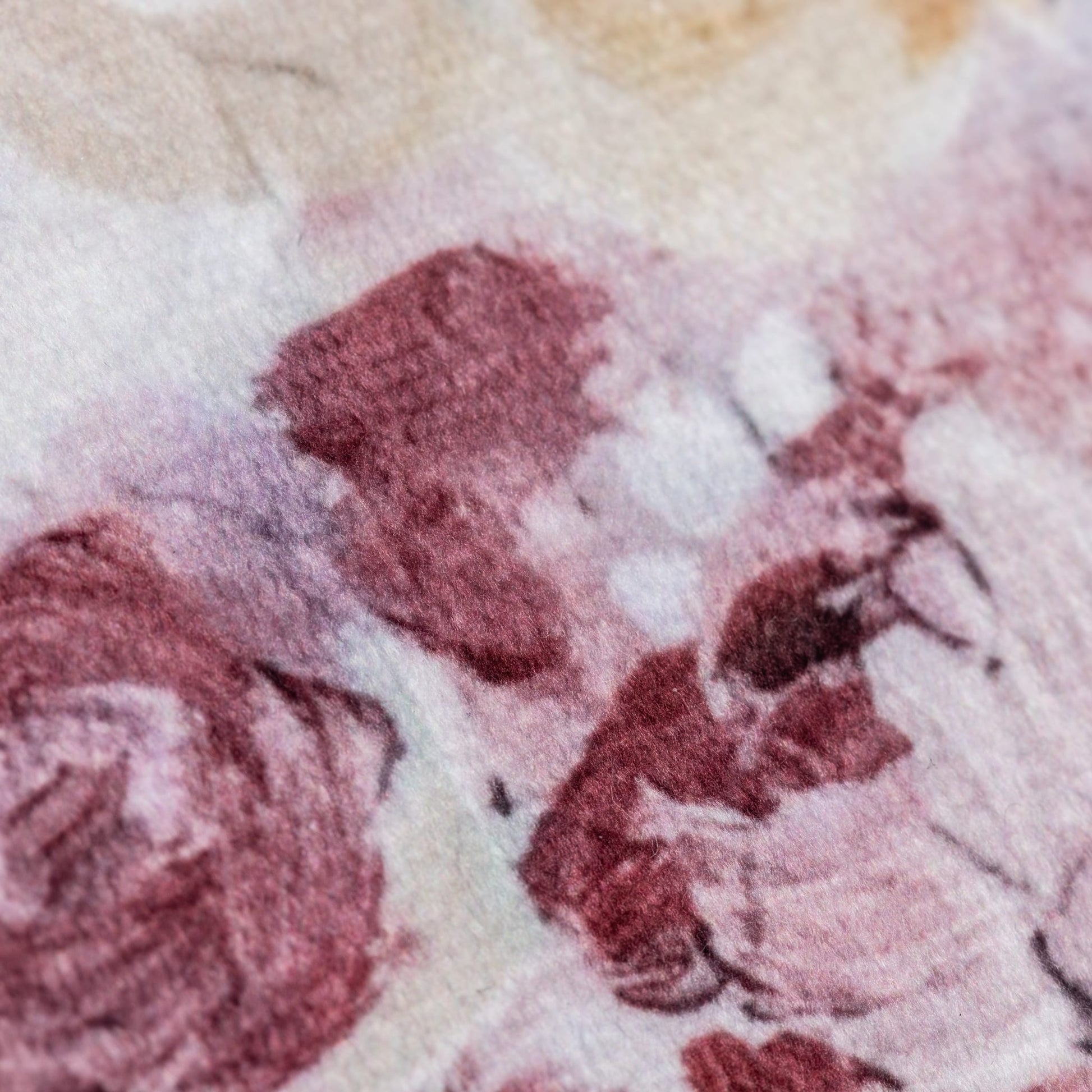 Close-up of a textured fabric with pink and beige patterns