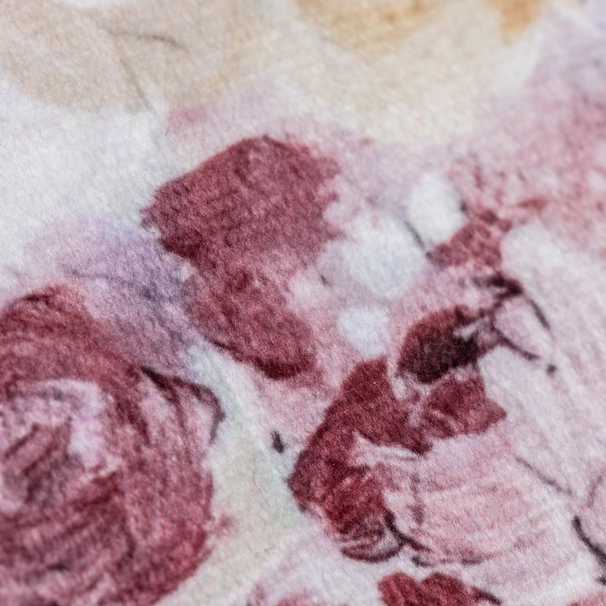 Close-up of a textured fabric with pink and beige patterns