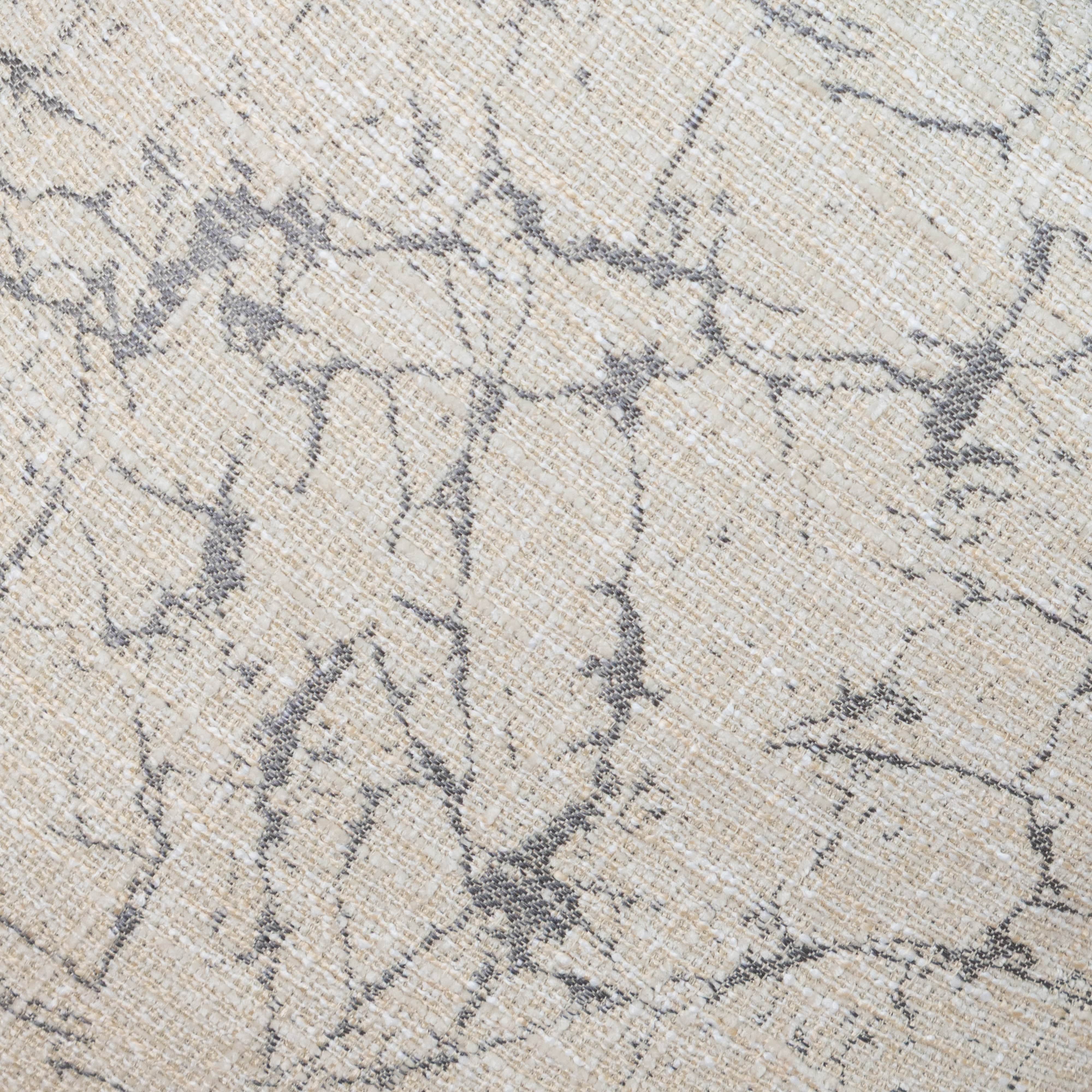 Close-up of a textured fabric with a subtle pattern on a neutral background