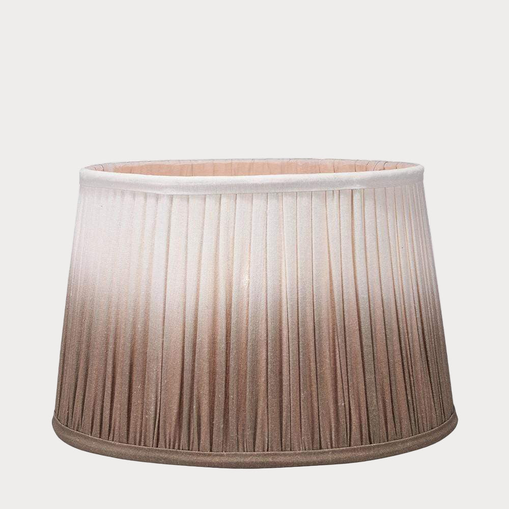 A pleated tapered shade with a ombre gradient color design, transitioning from white to taupe.