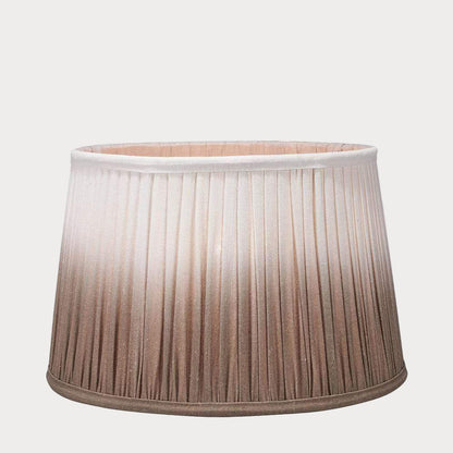 A pleated tapered shade with a ombre gradient color design, transitioning from white to taupe.