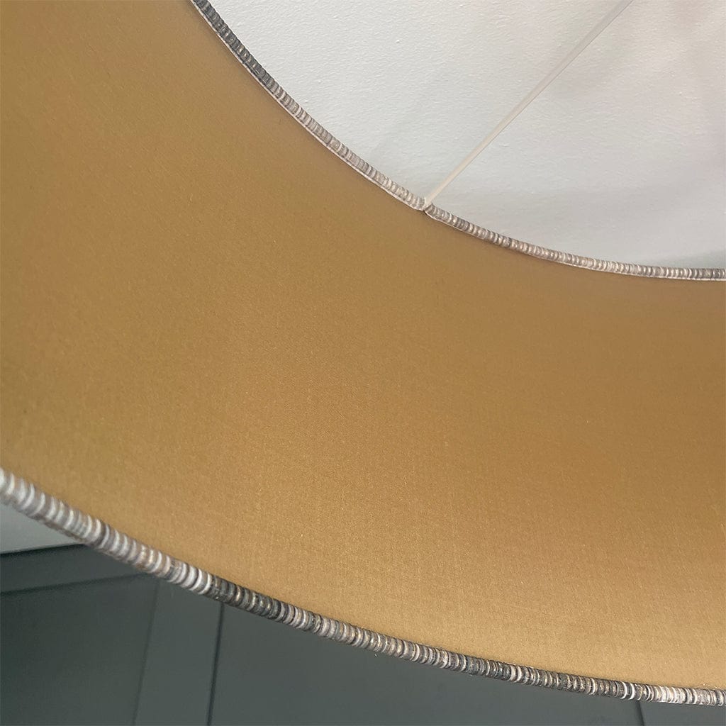 Close-up of a lampshade with beige fabric and white interior