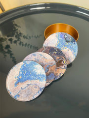 Set of marbled design coasters on a reflective surface