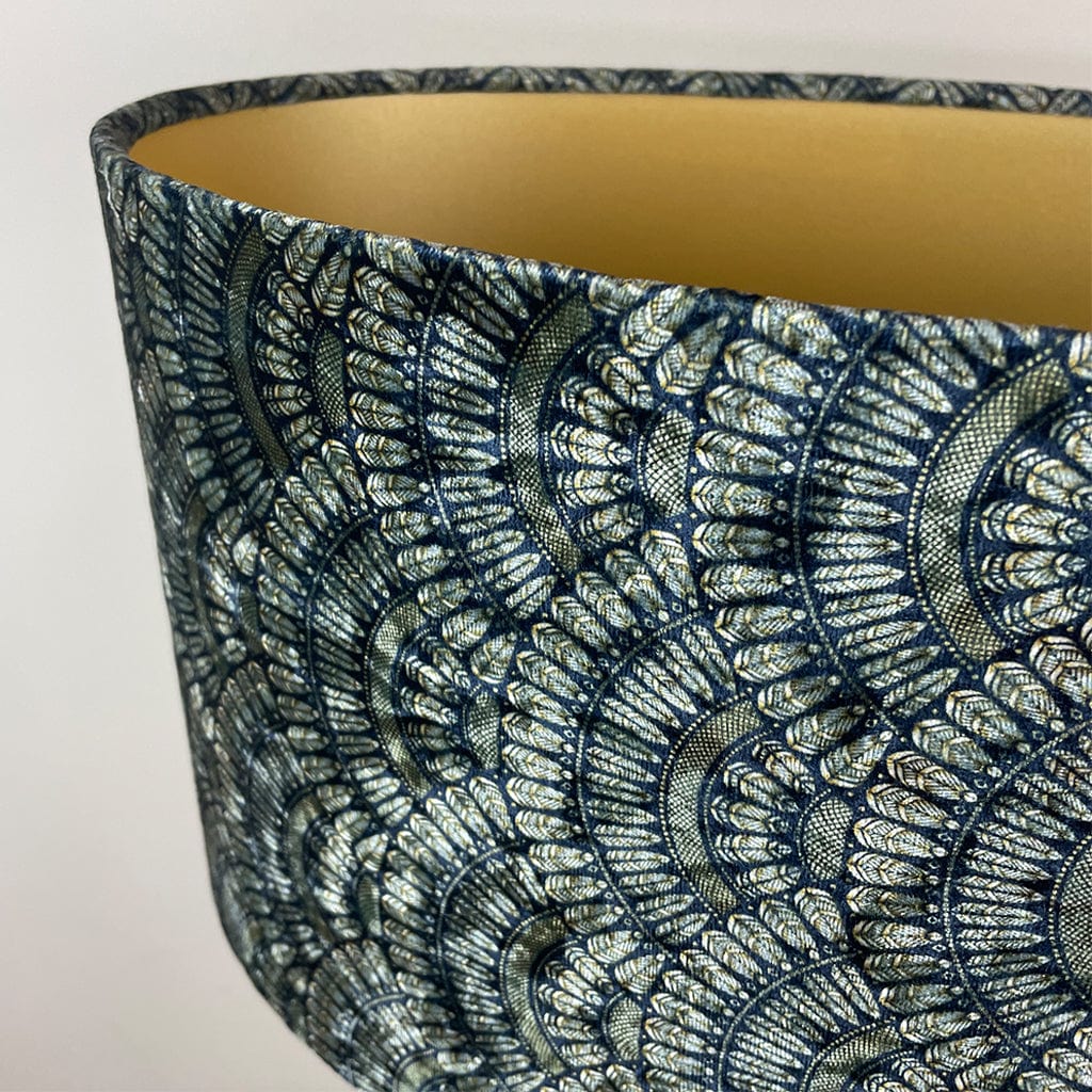 Decorative lampshade with intricate blue and gold pattern on a white background