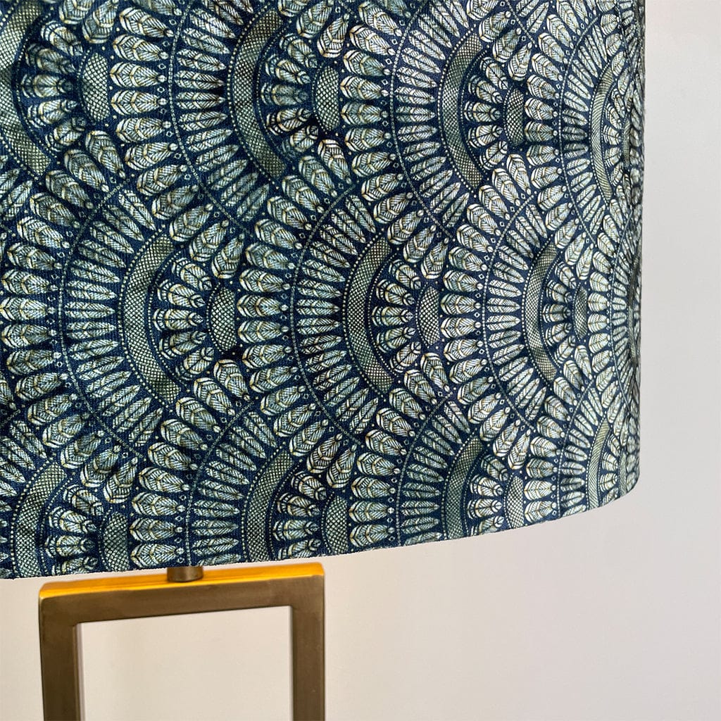 Decorative lampshade with a blue and gold Art Deco pattern on a plain background