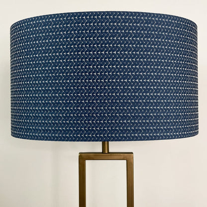 Lamp with a blue textured shade on a white background
