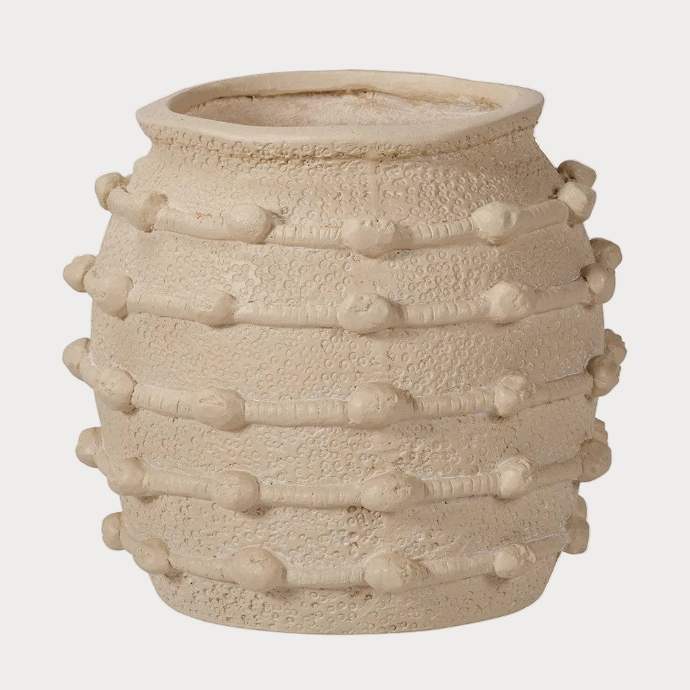 A beige, textured ceramic decorative planter with a geometric bobble design.