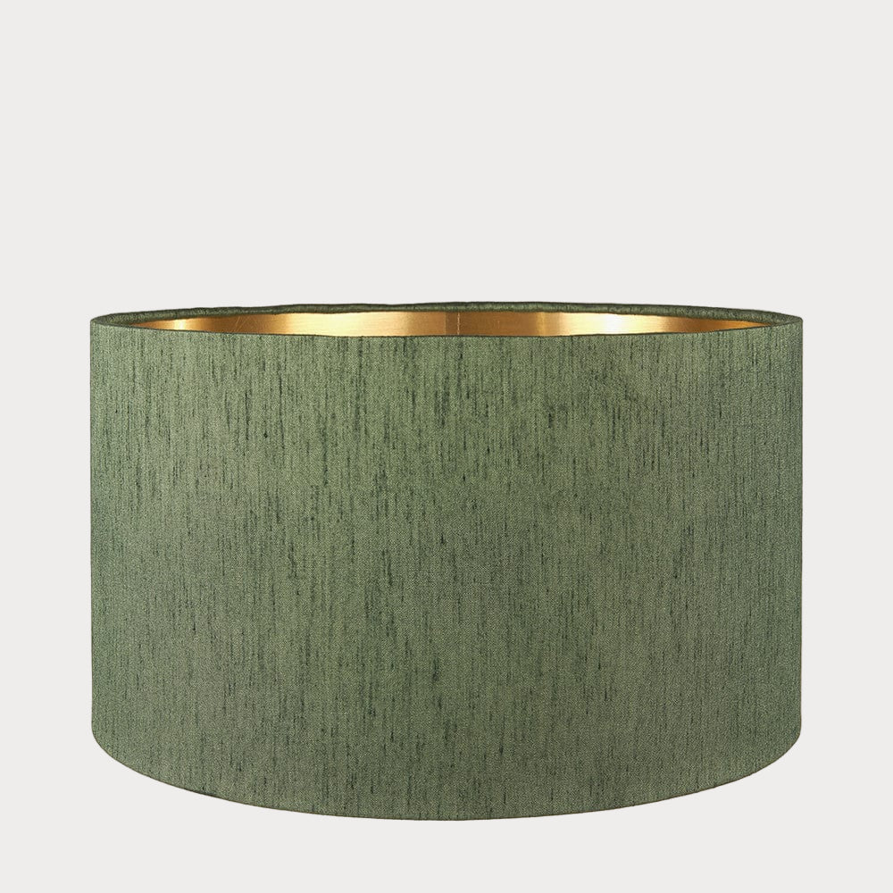 A cylindrical lampshade with a slubbed faux silk texture and a gold interior lining.