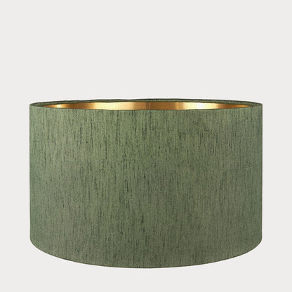 A cylindrical lampshade with a slubbed faux silk texture and a gold interior lining.