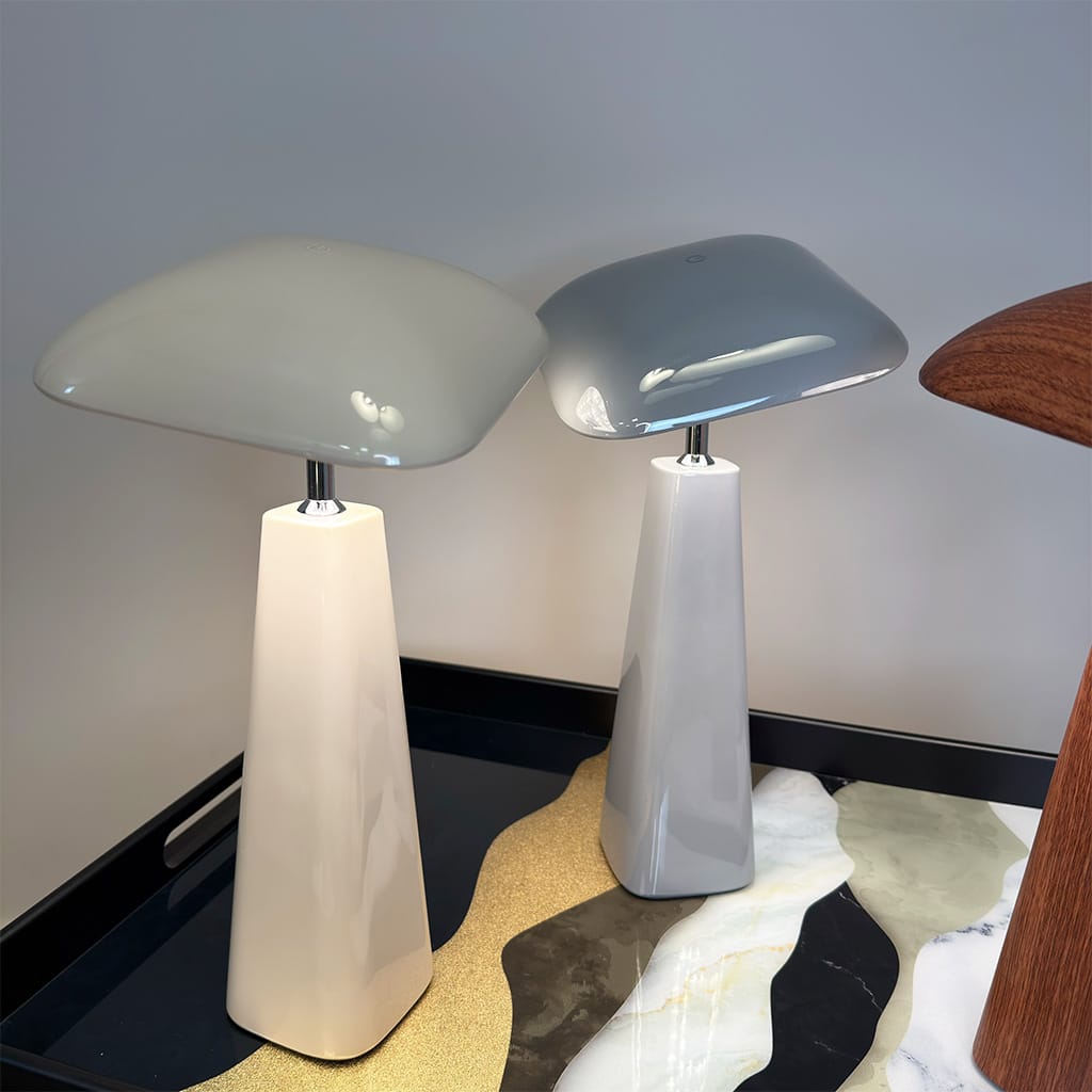 Two modern table lamps with different finishes on a neutral background