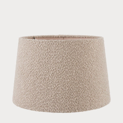 A taupe-colored boucle fabric tapered cylinder lamp shade.