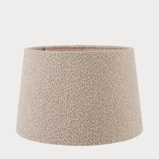 A taupe-colored boucle fabric tapered cylinder lamp shade.