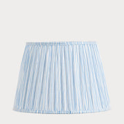 A tapered lampshade with a gathered cotton and mushroom pleat design, featuring a blue and white stripe pattern.