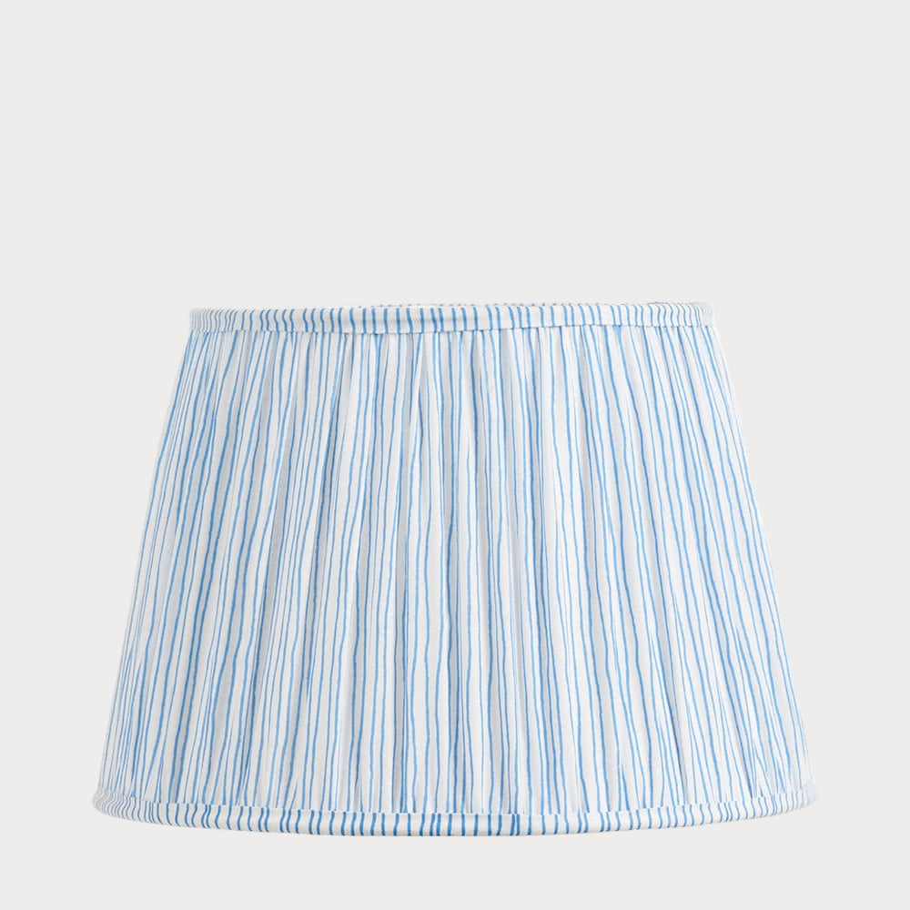 A tapered lampshade with a gathered cotton and mushroom pleat design, featuring a blue and white stripe pattern.