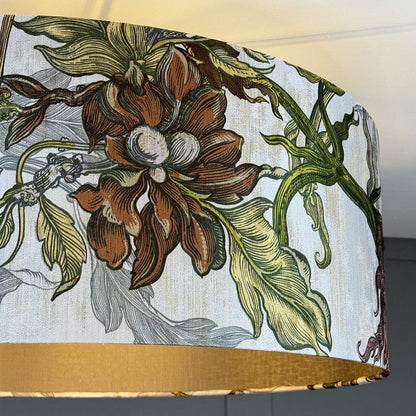 Floral patterned fabric with brown flowers and green leaves on a white background