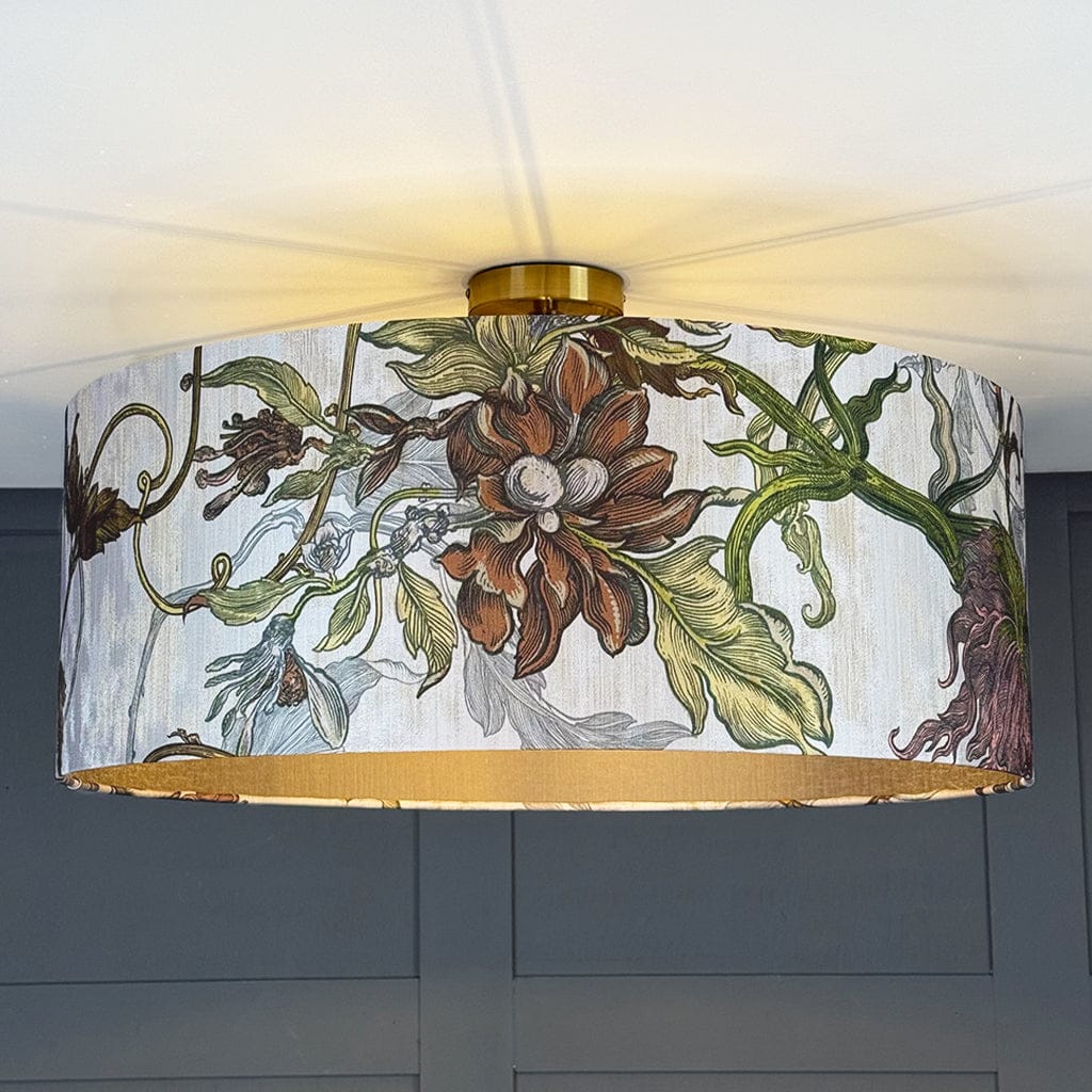 Floral patterned lampshade with gold trim on a ceiling light fixture.