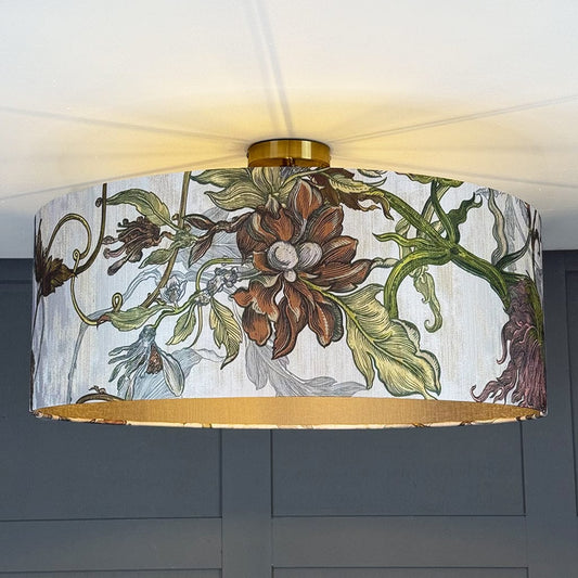 Floral patterned lampshade with gold trim on a ceiling light fixture.