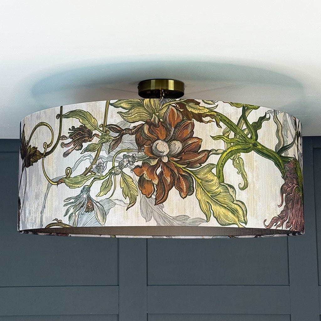 Decorative ceiling light fixture with floral design on a plain background