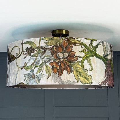 Decorative ceiling light fixture with floral design on a plain background
