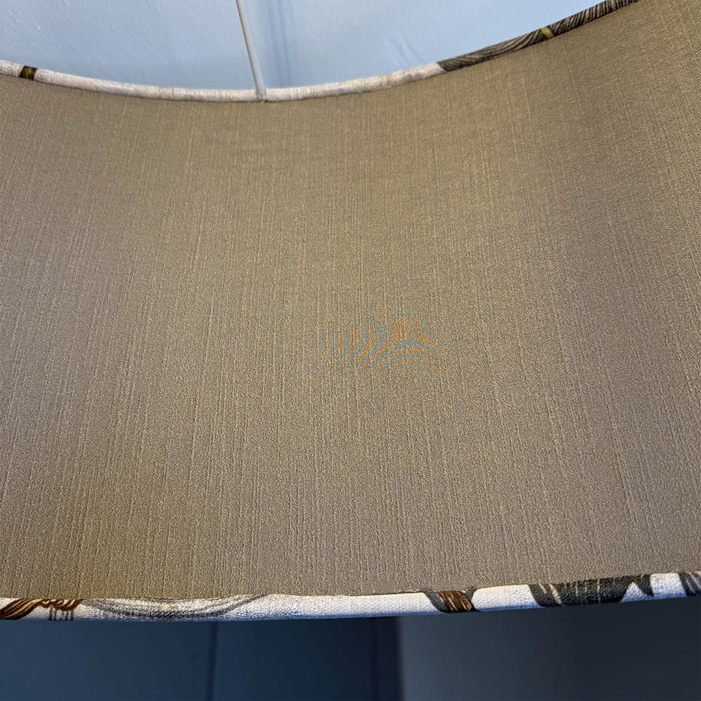 Close-up of a textured brown fabric with a patterned border.