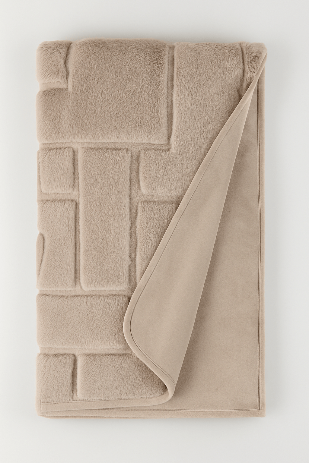Beige soft throw with textured pattern on a white background