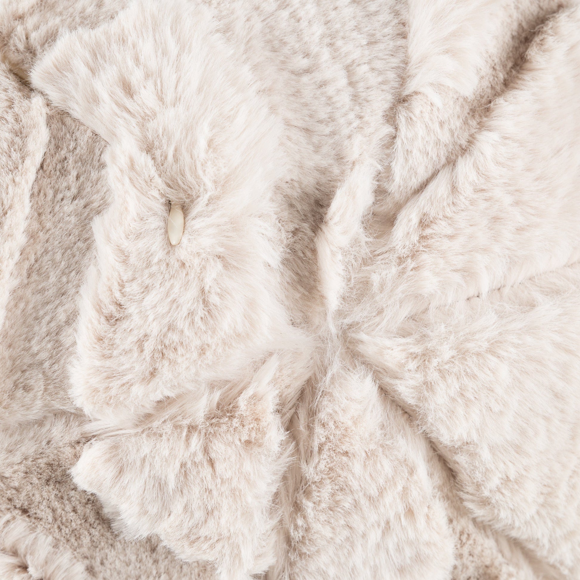 Close up of a natural beige fluffy cushion